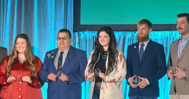 Mr Torres on stage with other teachers