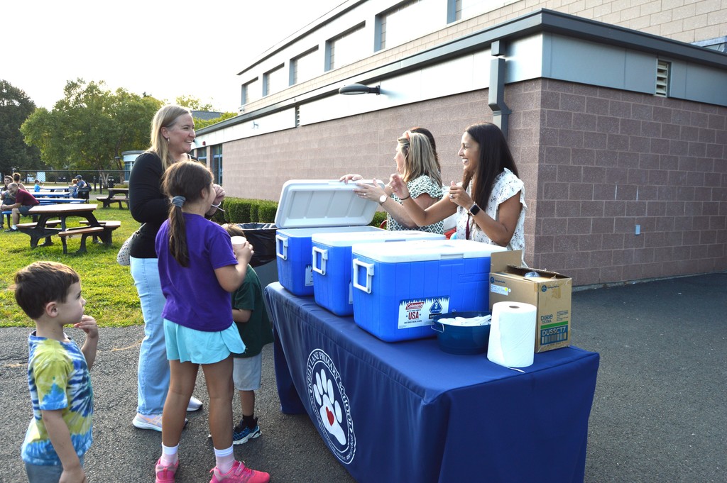 Mrs. Loveland and Mrs. Bava giving ice cream out to families