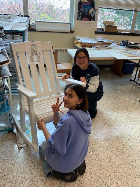 Two students working on the chairs 