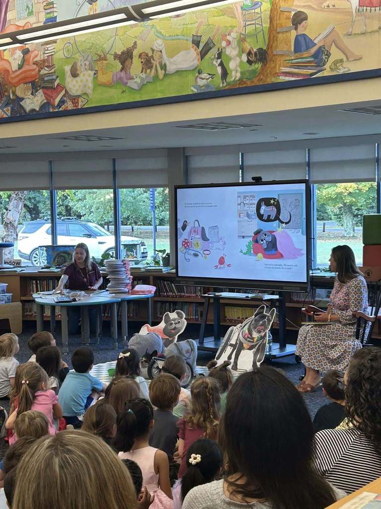 Students listening to read aloud of the book Ivy the Determined Dog