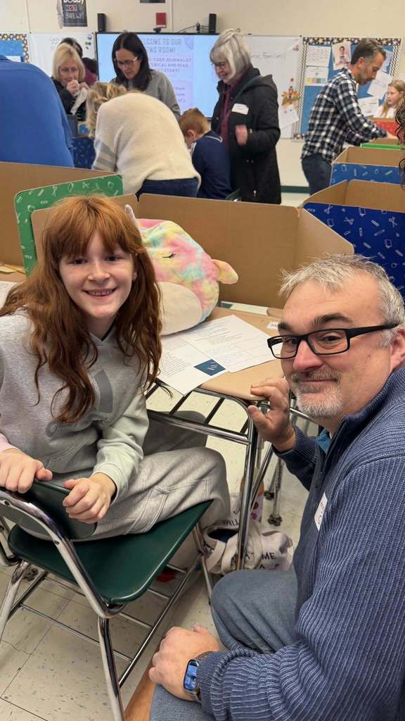Father and daughter reviewing her school project
