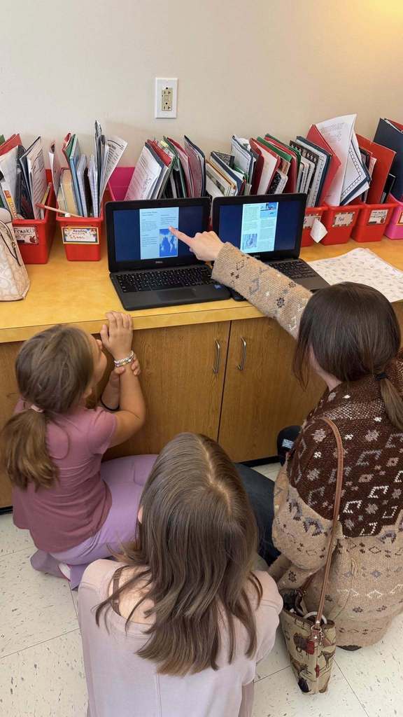 Students showing a parent their projects