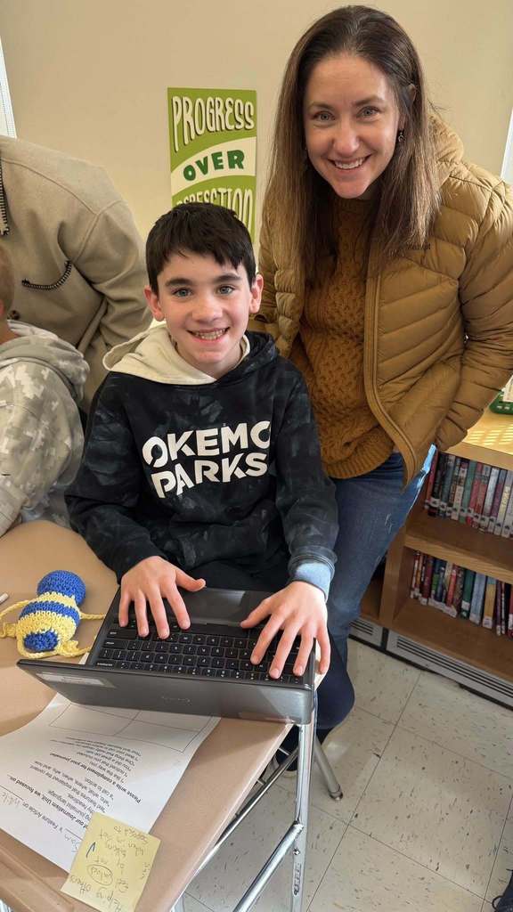 A son with his mom showing her his project