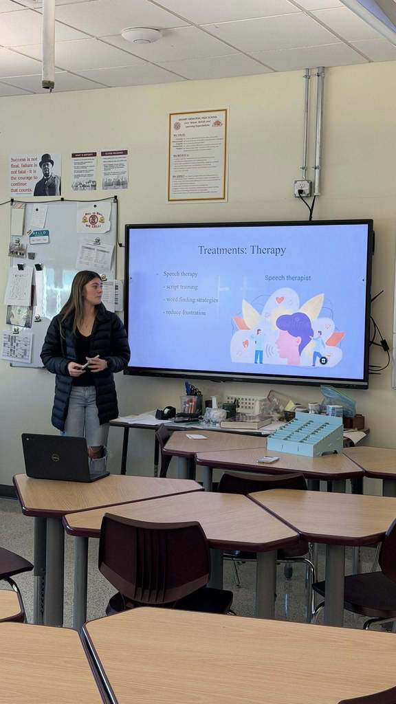 A student presenting their capstone project on therapy treatments 