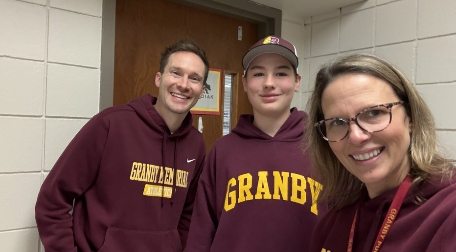 Assistant Principal Alex Schwartz and Principal Heather Tanis with a student