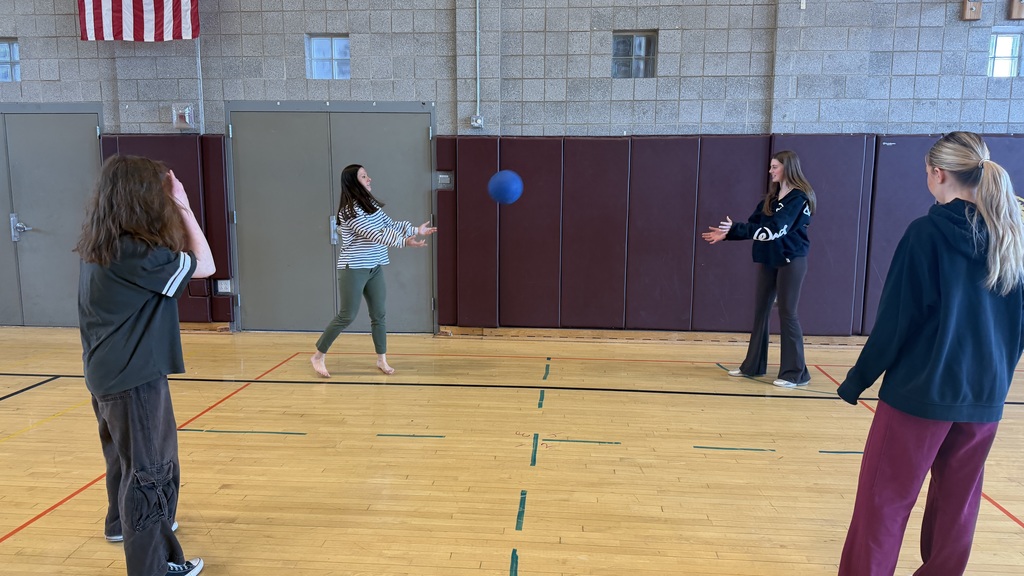 Assistant Principal Hannah Dill playing a gym game with students