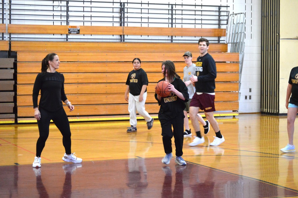 Assistant Principal Hannah Dill playing basketball with students