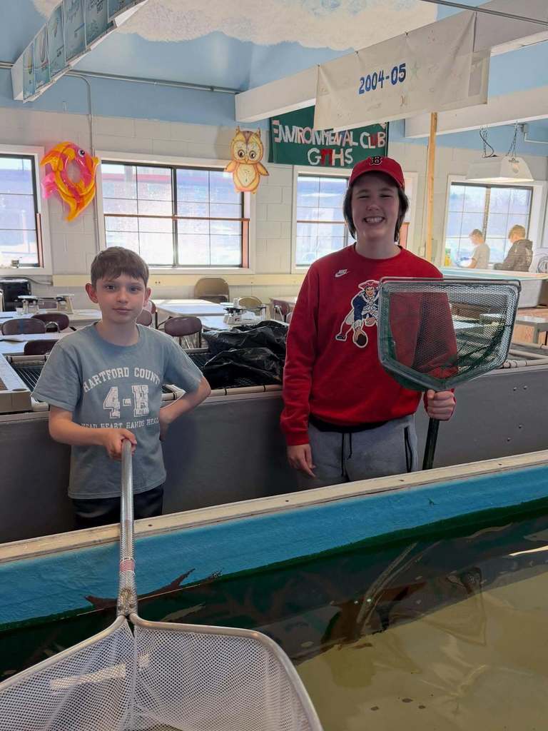 Two pictures holding fishing nets