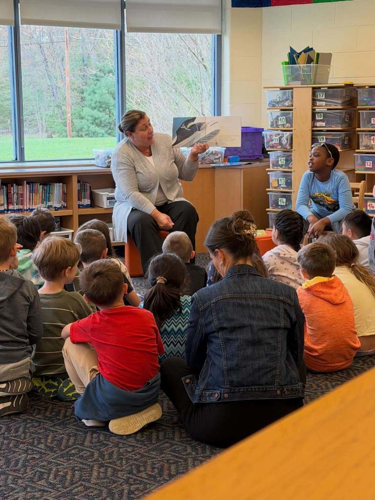 Assistant Superintendent Parsons reading to students