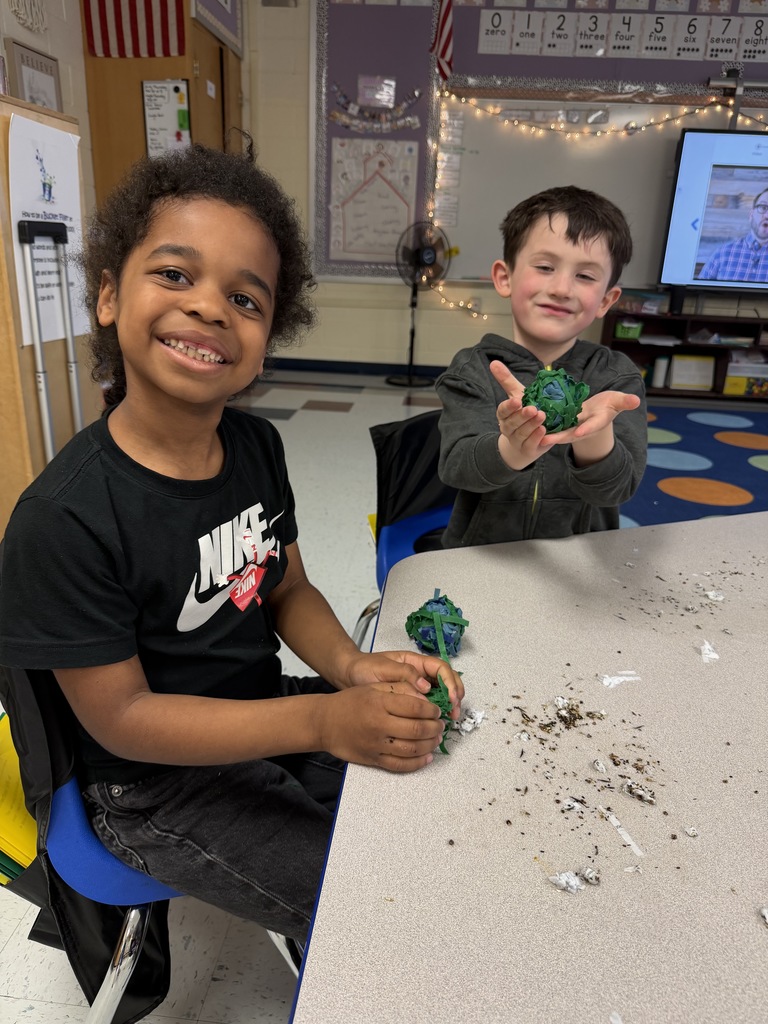 Two students with their Earth Day projects.