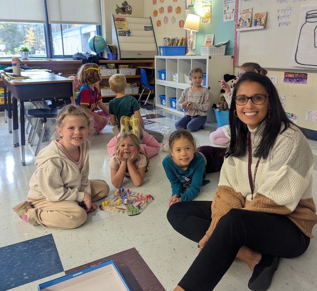 Kelly Lane Principal sitting with students