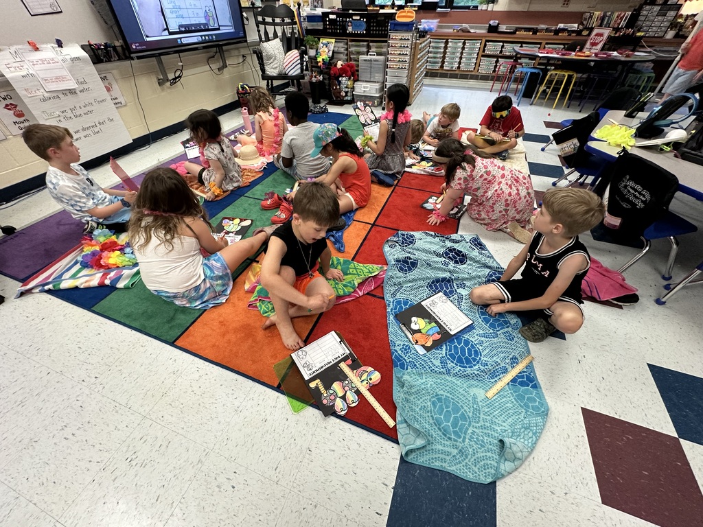 Kids on blankets writing.