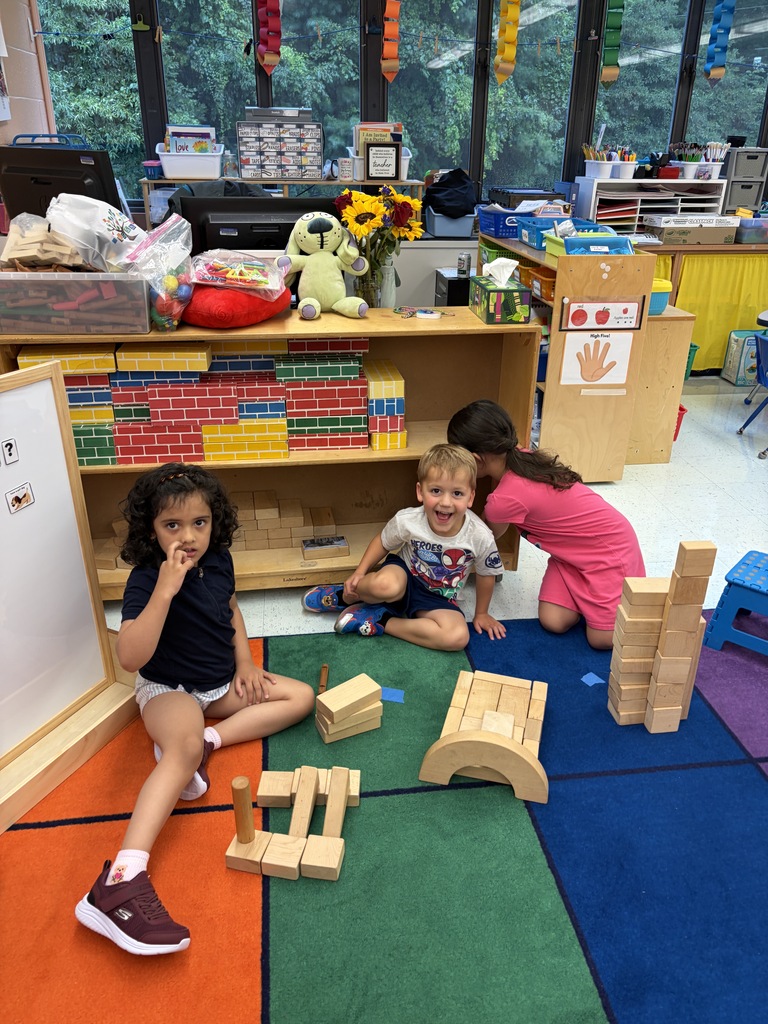 Students building with building blocks.