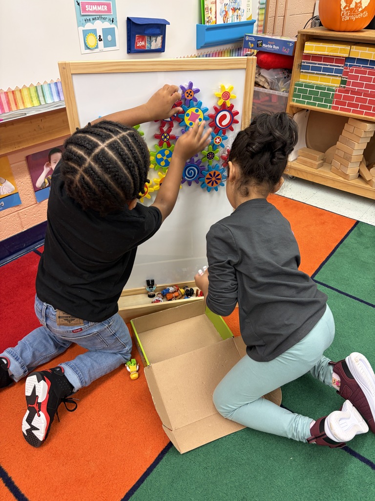Students playing with gears.