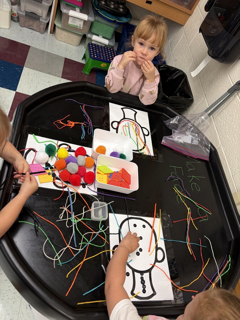 Students using pom poms and wicky sticks.