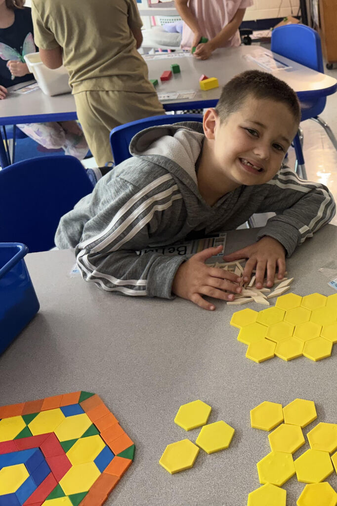 Boy placing shapes.