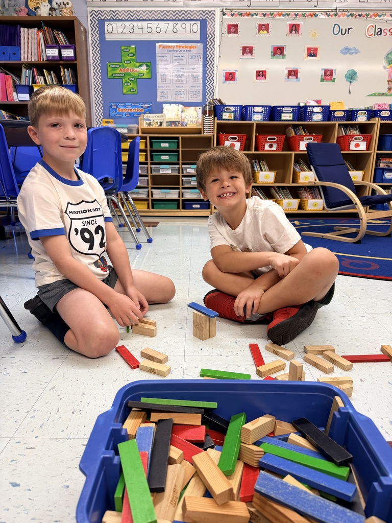 Boys playing with wooden blocks.
