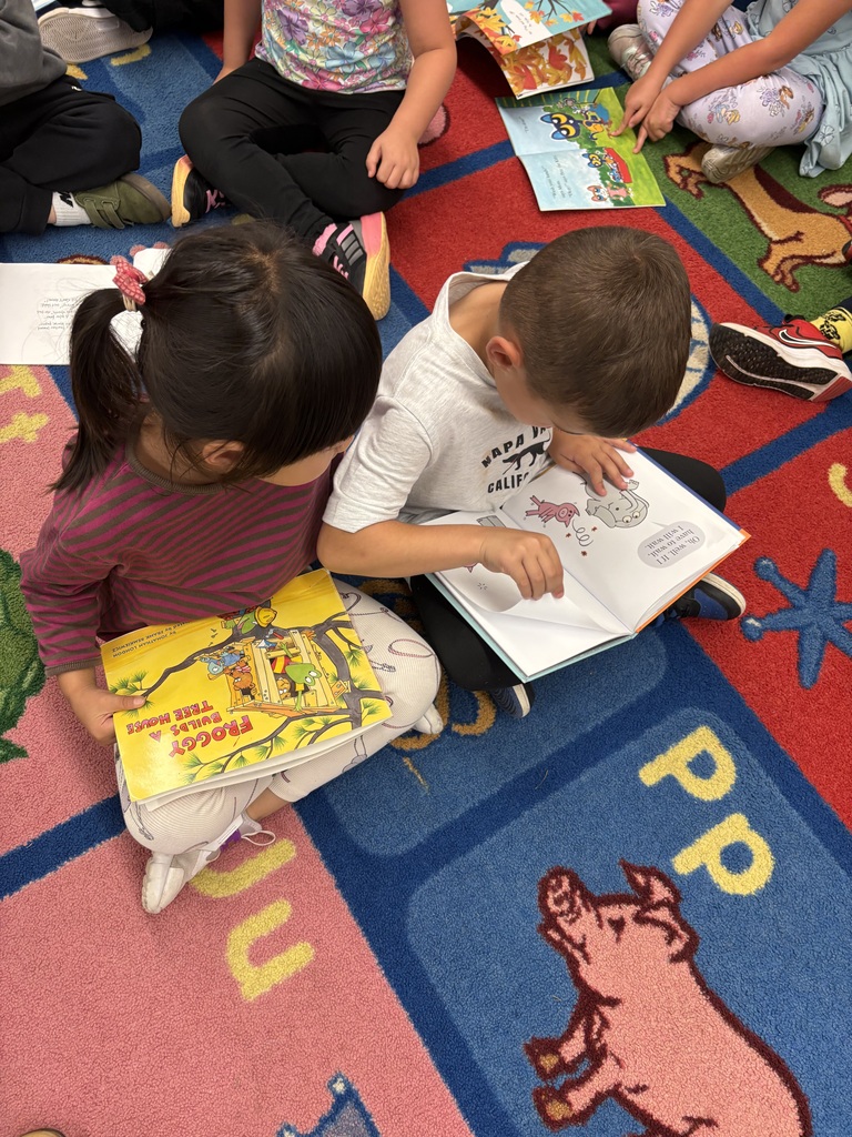 Boy and girls buddy reading.
