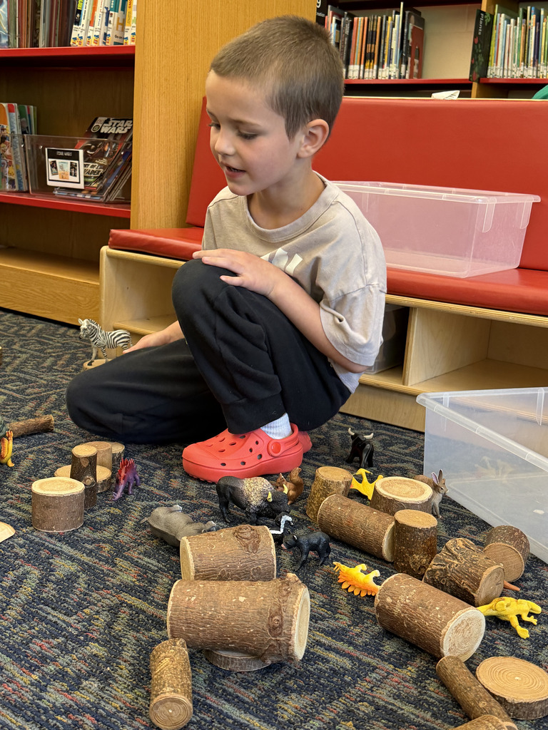 Students stacking logs.