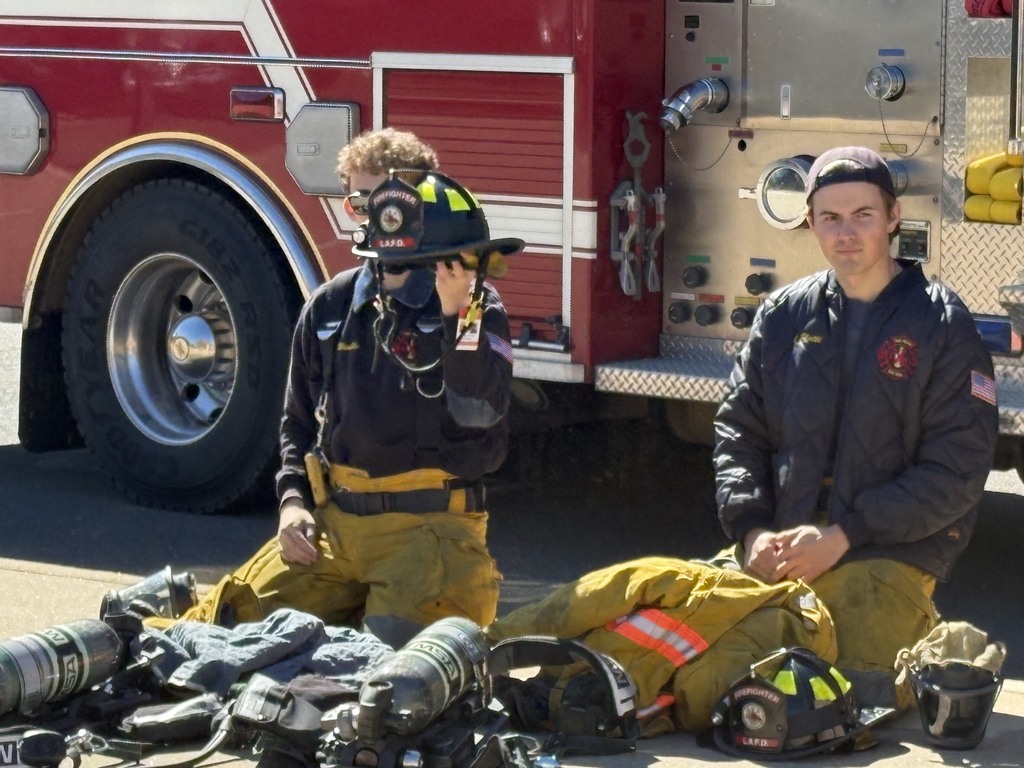 Firefighters showing gear.