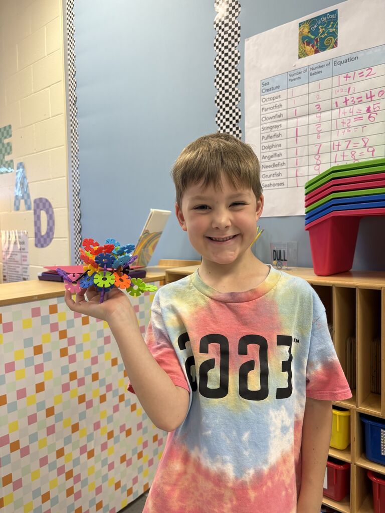 Boy holding creation.