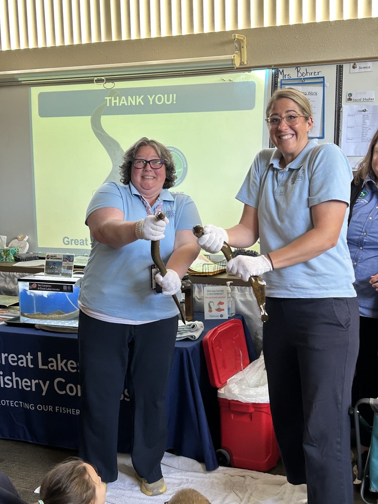 teachers holding live eels