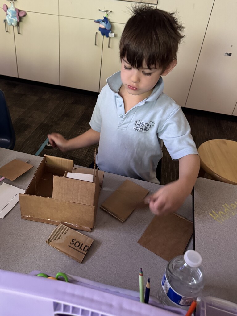 boy creating with a box