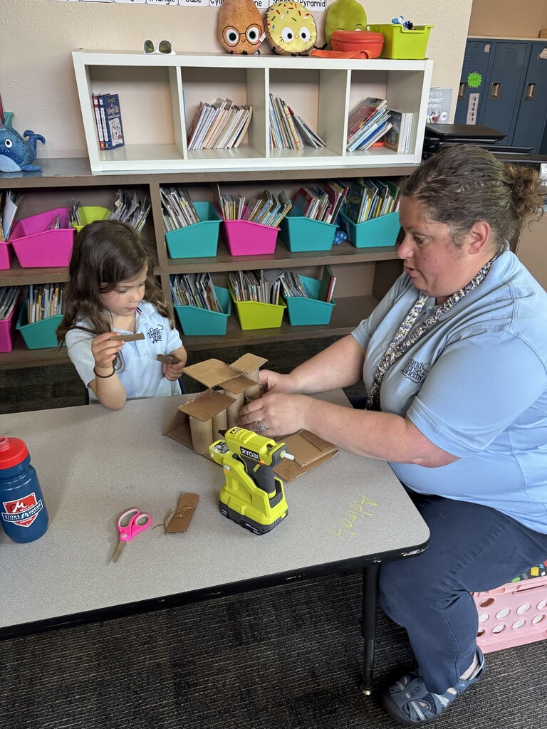 girl and teacher creating with a box
