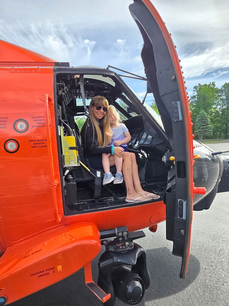 student, teacher and coast guard helicopter