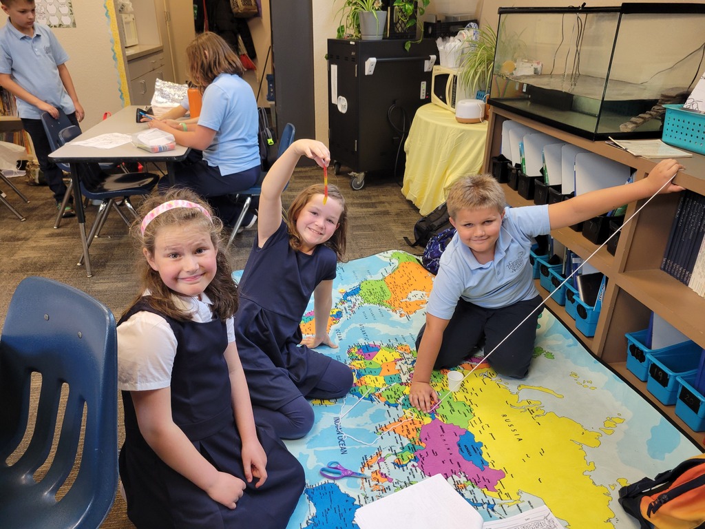 students sitting on a map