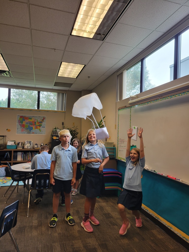 students holding a handmade parachute