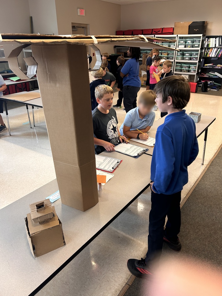 older students teaching younger students in class