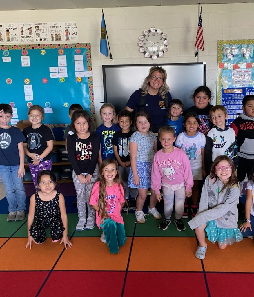Students pose with Firefighter