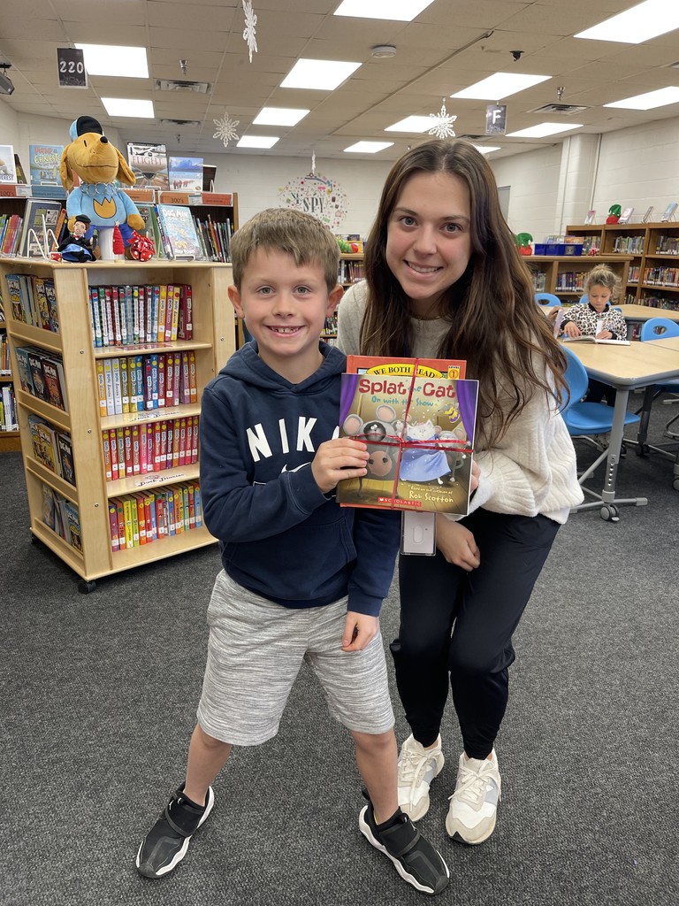 Students pose with books