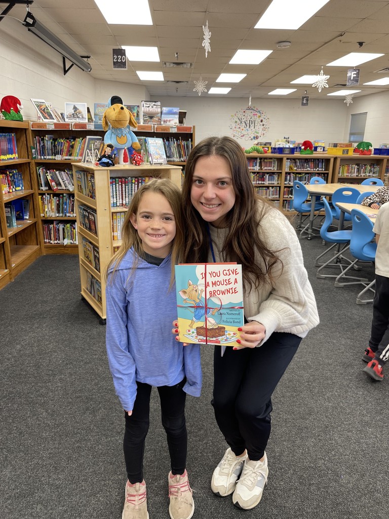 Students pose with books