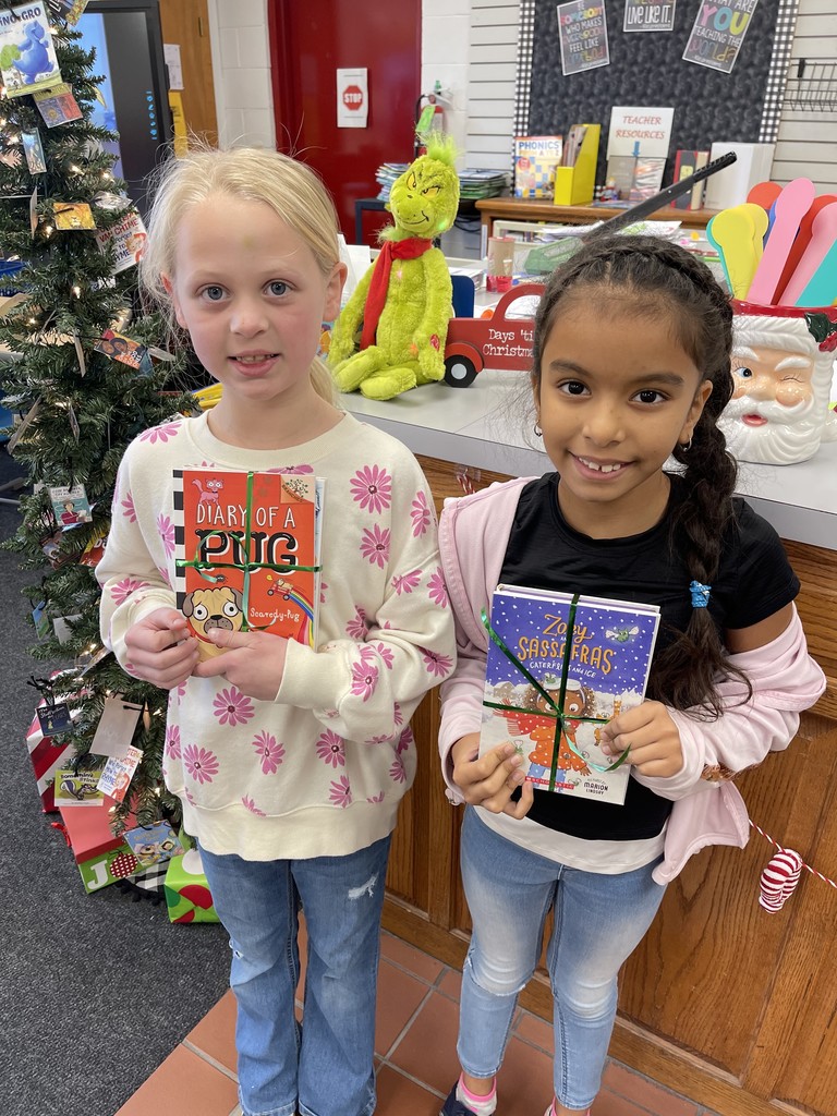Students pose with books