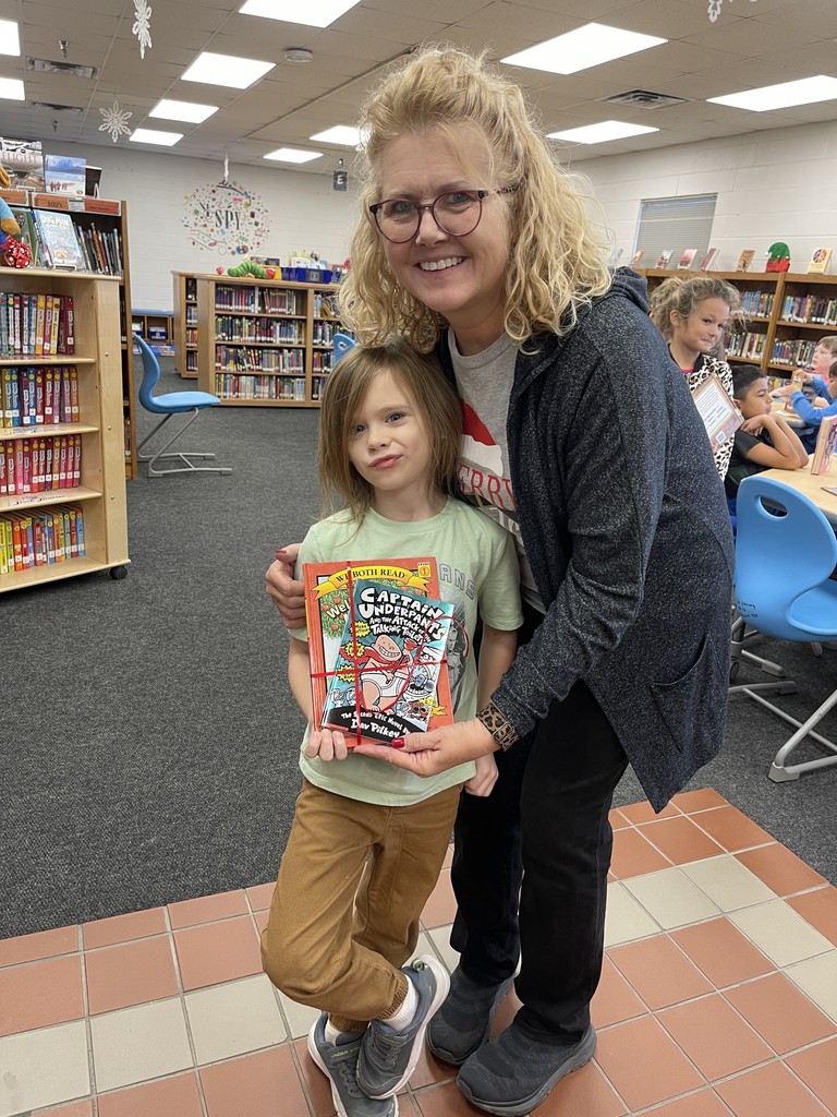 Students pose with books