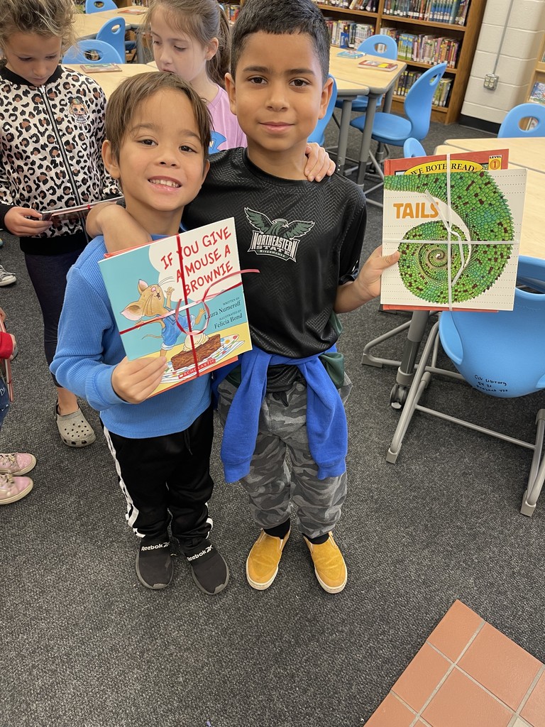 Students pose with books