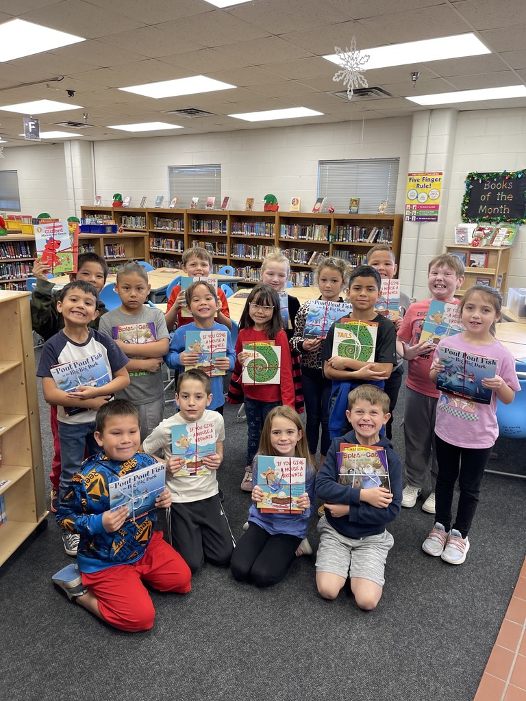 Students pose with books