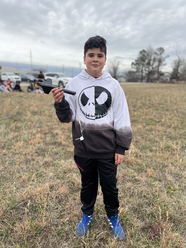 Students pose with rockets