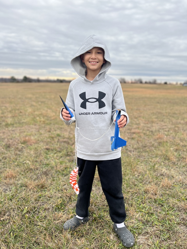 Students pose with rockets