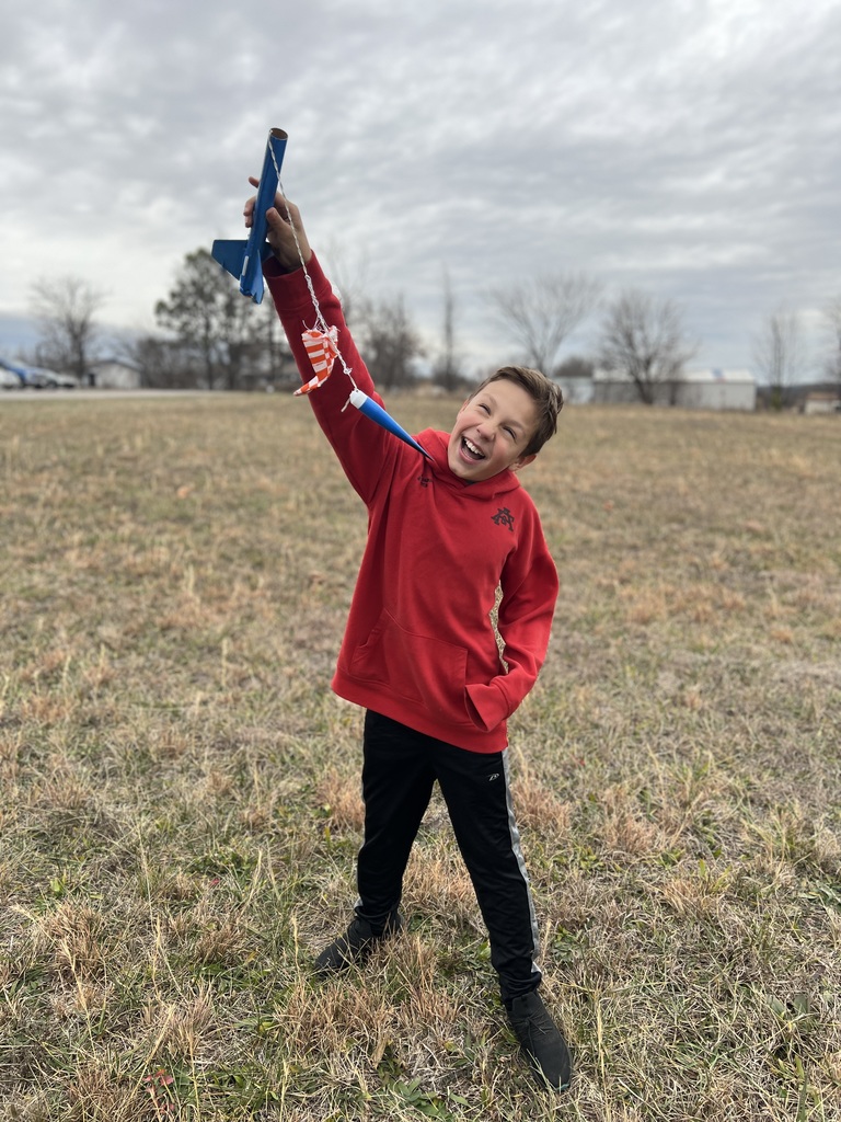 Students pose with rockets