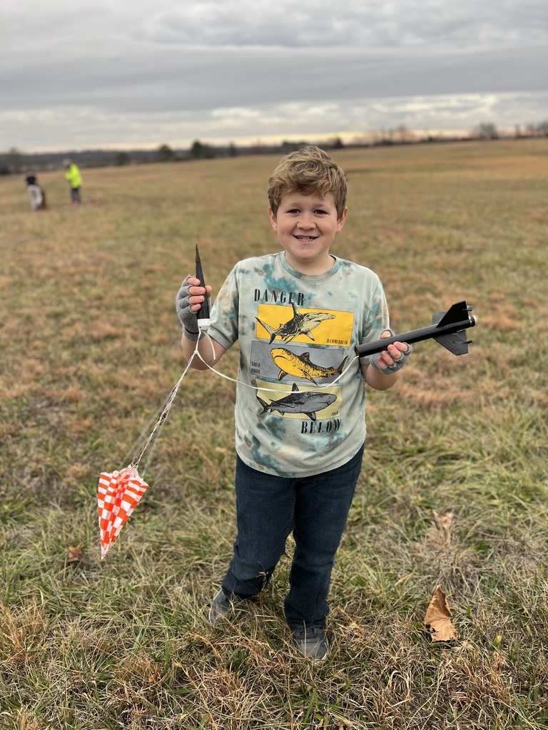 Students pose with rockets