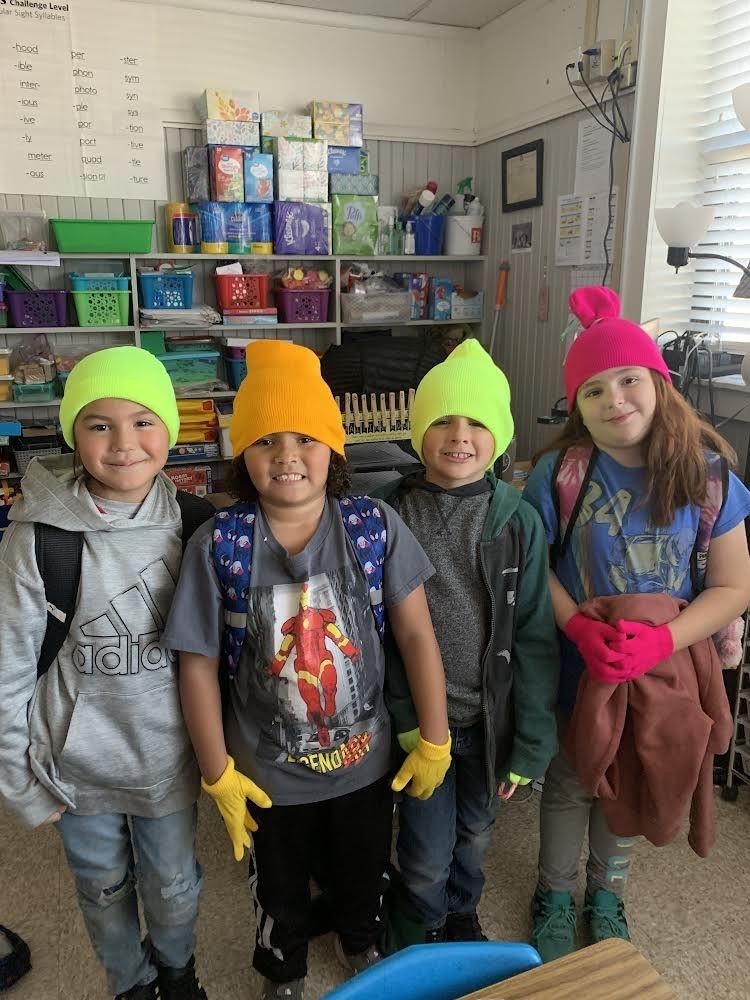 Students show off their hats and gloves