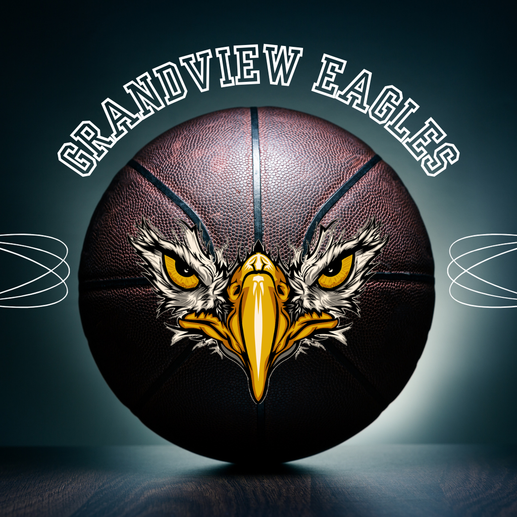 A close-up of a basketball on a dark tabletop with a fierce illustrated eagle face, including sharp yellow beak and intense eyes, printed on the front of the ball, and the curved text “GRANDVIEW EAGLES” in bold white letters above.