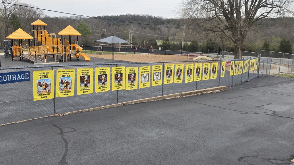 Fence with poster celebrating highlights from  past map tests