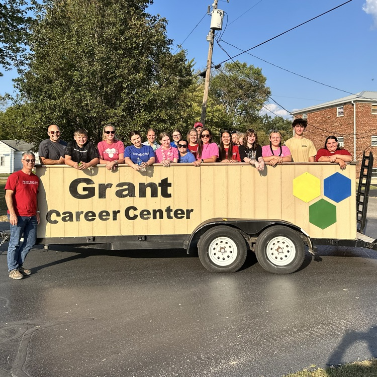 Grant students and staff standing on the Grant trailer. Mr. Daulton is standing in front