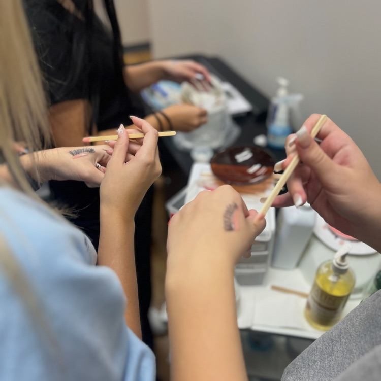 Cosmetology students practicing waxing!