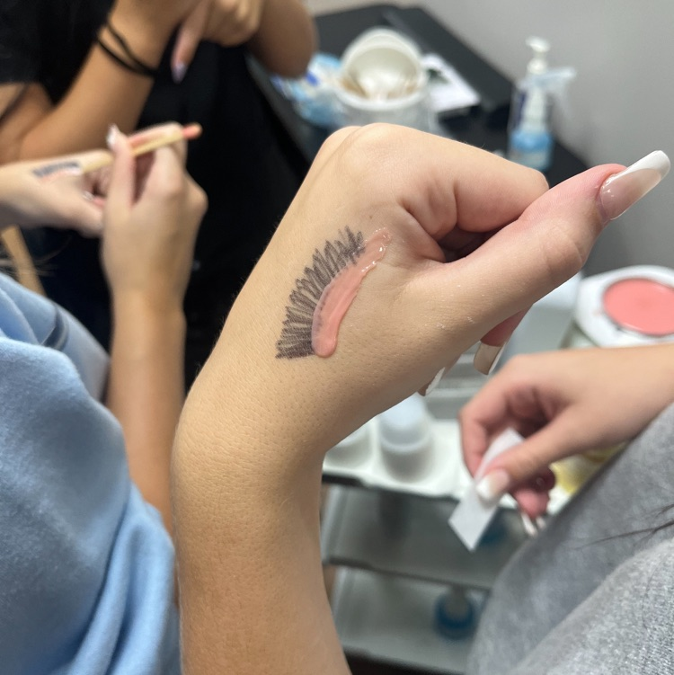 Cosmetology students practicing waxing!