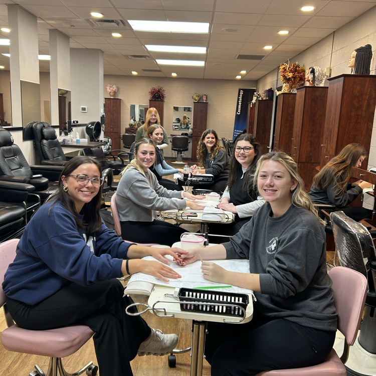 junior cosmetology students taking in some clients from other programs for manicures!